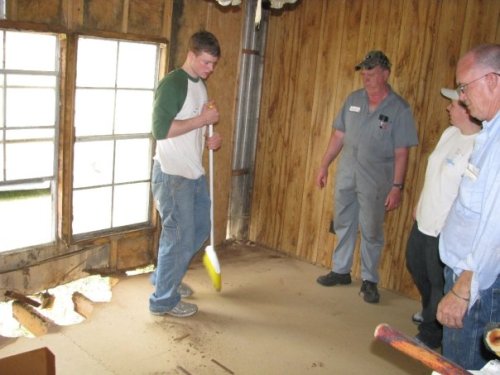 Jimbo, Olga, and Steve supervise Stew sweeping the newly-carpetless floor.